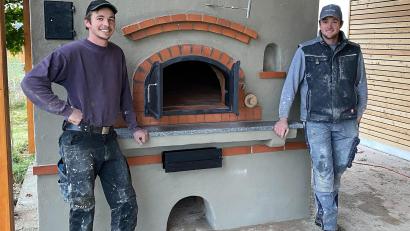 Bild: nza
Backofenbauer Matthias Maurer (von rechts) und sein Bruder Jonas errichteten in Krummennaab einen mit Holz befeuerten Hausbackofen.