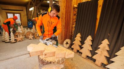 Bild: Martin Hertel/exb
Alexander Schirbel, Auszubildender am Forstbetrieb Fichtelberg, schnitzt mit der Motorsäge einen kleinen Weihnachtsbaum aus Holz