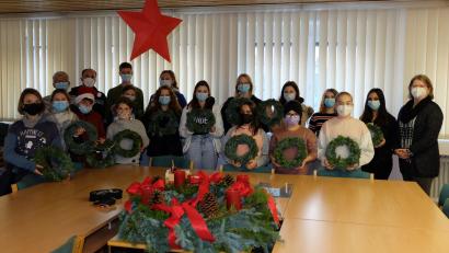 Bild: Mittelschule Mitterteich/exb
Die am Adventskranzbinden beteiligten Kinder und Jugendlichen der Mittelschule Mitterteich zusammen mit Rektorin Gisela Kastner (rechts). Auch für das Lehrerzimmer wurde ein Kranz angefertigt.