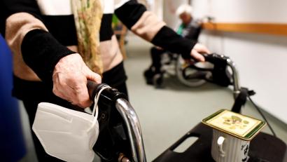 Symbolbild: Angelika Warmuth/dpa
Eine Heimbewohnerin schiebt ihren Rollator mit FFP-2 Maske durch einen Gang in einem Altersheim. Im Altenheim in Waldsassen haben sich fünf Bewohner mit dem Coronavirus infiziert.