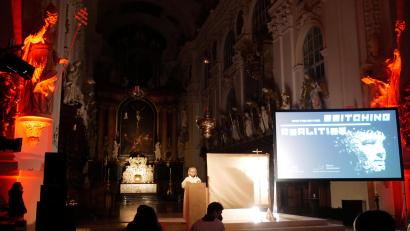 Bild: hmr
Gemeindereferentin Gertrud Hankl am Ambo neben dem Volksaltar in der Basilika, die mit umfangreicher Licht- und Tontechnik sowie zwei riesigen Leinwänden für den Kino-Gottesdienst vorbereitet worden war.
