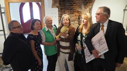 Bild: bl
Museumsgestalter Wolfgang Engel, Museumsleiterin Carola Reul, die Vertreterinnen der Nähgruppe Theresia Eichinger, Cornelia Schäfer und Maria Ostler-Scharl (von links) bewundern mit Bürgermeister Richard Tischler die Nachbildung des Ananas-Pokals.