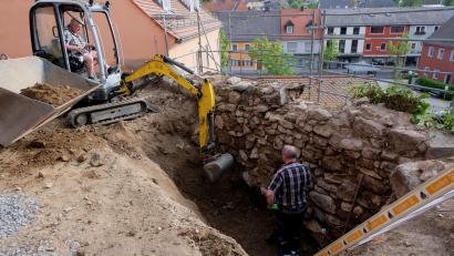 Bild: le
Die alte Befestigungsmauer im denkmalschützten Ensemble Friedhofring mit Pfarrkirche, Pfarrhaus und Pfarrhof, ist das älteste Mauerwerk im 1074-jährigen Markt. Seit einigen Tagen wird sie einer gründlichen Sanierung unterzogen.