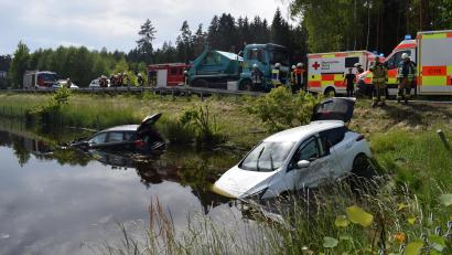 Bild: szl
Vier mittel bis schwer verletzte Personen sind die Bilanz eines Verkehrsunfalls am Montagnachmittag an der B15 bei Mooslohe südlich von Tirschenreuth. Die beiden Autos landeten im Weiher neben der Straße.