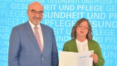 Bild: StmGP/exb
Peter Bauer (links), der Patienten- und Pflegebeauftragte der Bayerischen Staatsregierung, zeichnet Cornelia Lochner aus Amberg aus.