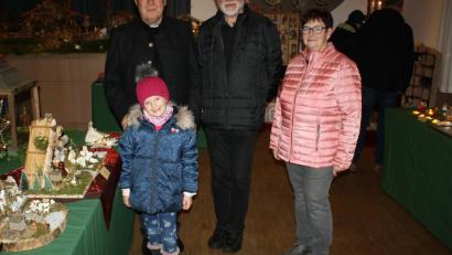 Bild: bjp
Der ganze Stolz der sechsjährigen Leonie Matz ist ihre selbst angefertigte Weihnachtskrippe, neben der sie hier zusammen mit Monsignore Martin Martlreiter (Vorsitzender des Verbands Bayerischer Krippenfreunde), Stadtpfarrer Edmund Prechtl und Uroma Elke Mirwald steht.