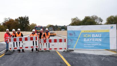 Bild: mab
Bürgermeister Peter Neumeier, Bauoberrat Hannes Neudam (Mitte) geben mit Vertretern der bauausführenden Firma den Verkehr über die Behelfsbrücke frei. "Die Brücke hält" stellte die Besatzung des Löschfahrzeuges der Feuerwehr im HIntergrund fest, die als Erste die Notbrücke passierten.