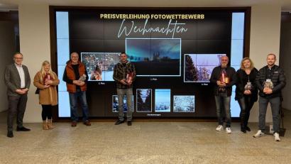 Bild: Stadt Waldsassen/exb
Im Foyer des Rathauses Waldsassen wurden die Gewinner des Fotowettbewerbs der Stadt Waldsassen prämiert. Im Hintergrund auf dem großen Bildschirm die Motive, die von der Jury als die besten Einsendungen ausgewählt wurden. Im Bild: (von links) Bernd Sommer, Melissa Hutzler, Peter Bindl, Florian Rosner, Robert Gruber, Manuela List und Simon Nickl.