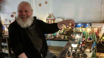 Bild: Pia Bayer/dpa
Horst Gründel sitzt vor seinem rund acht Quadratmeter großen Miniatur-Weihnachtsmarkt.