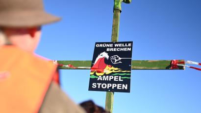Bild: Lars Penning/dpa
"Grüne Welle brechen, Ampel stoppen" steht auf einem Plakat der Bewegung "Land schafft Verbindung" (LSV) an einem Kreuz mit einem Gummistiefel an der Spitze.