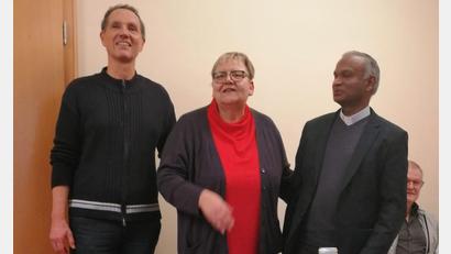 Bild: Maria Scheurer/exb
Pfarrer Johnson (rechts) und Joachim Kellner (links) verabschieden Annette Walther.