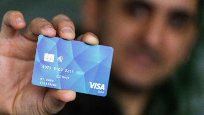 Bild: Philipp von Ditfurth/dpa/Symbolbild
Ein Geflüchteter hält eine Debitcard in der Hand.