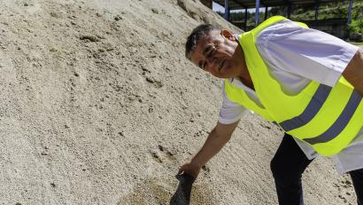Bild: Hösamer
Matthias Schlamminger greift in feinkörnigen Sand: Dieses Material besteht auch aus dem Beton der abgerissenen, Schwandorfer Naabbrücken.