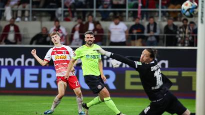 Bild: Daniel Löb/dpa
Der Regensburger Dominik Kother (links) trifft in dieser Szene gegen den Wiesbadener Torwart Florian Stritzel (rechts) zum 2:2 genau in den Torwinkel.