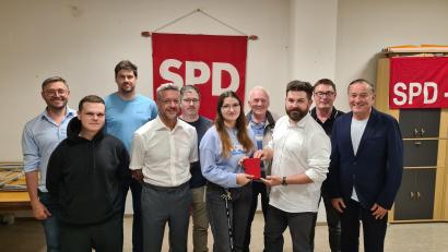 Bild: Martin Schmidberger/exb
Der neue Vorstand der Neustädter SPD. Vorsitzender Sebastian Giering überreicht Lena Groz das rote Parteibuch.