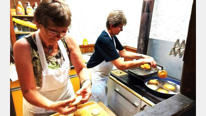 Bild: lg
Anne Hammerer und Angelika Treiber backen in der Küche des Bergweberhofs goldbraune Küchel, die zu den Schmankerln am Eulenberg zählen.