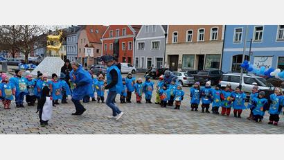Bild: u
Die St.-Wolfgang-Kinder kommen als Fischschwarm zum Marktplatz, stülpen dem Bürgermeister ein Fischkostüm über und setzen ihm ein Haifischmaul auf.. Als Haifisch tanzt er mit den Kindern zu Liedern wie „Der keine Haifisch“ oder „Fünf kleine Fische“.