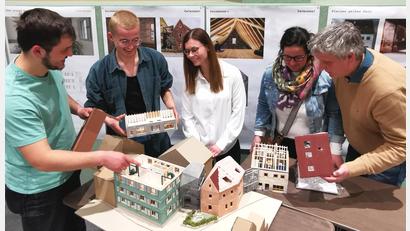 Bild: Portner
Spannende Einblicke: Die beiden Studenten Lukas Prokopetz (von links) und Jonas Pirkl erklären Maria Ruß vom Bauamt Oberviechtach sowie dem Ehepaar Hofmann ihre Ideen für die Sailergasse 5, 7 und 9.