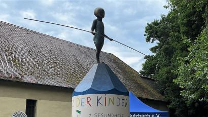 Bild: Susanne Schwab
Die von Robert Diem erstellte Litfaßsäule mit Grafiken von Marie Dörfler und einer Skulptur von Hanna Regina Uber auf dem neuen Platz der Kinderrechte symbolisiert den Balanceakt zwischen Schutz und Freiheit, der bei der Kindererziehung zu bewältigen ist und stets berücksichtigt werden sollte.