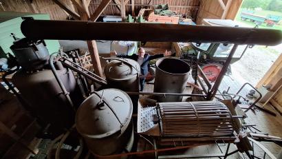 Bild: bl
Museumsleiter Tobias Hammerl (im Hintergrund) verdeutlich die Dimensionen der Dämpfkolonne mit dem Feuerkessel (links), den Töpfen für die Kartoffel und der Waschanlage für die Knollen (rechts vorne). Der Komplex auf vier Eisenrädern mit umgeklapptem Kamin gehört zu den Ausstellungsstücken, die im Großobjekte-Depot unterkommen sollen.