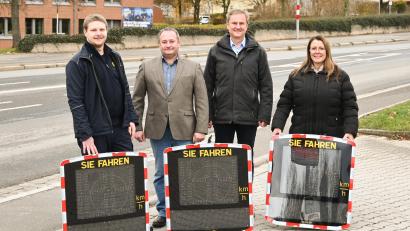 Bild: Sibylle Sandner/ Stadt Amberg
Von links nach rechts: Über die neuen Anzeigetafeln in Amberg, die für mehr Sicherheit sorgen sollen, freuen sich Verkehrsüberwacher Alexander S., Rudolf Söldner (Leiter des Straßenverkehrsamts), Bernhard Mitko (Referent für Recht, Umwelt und Personal) und Laura Hamori-Schießlbauer, (Assistenz im fließenden Verkehr im Zweckverband).