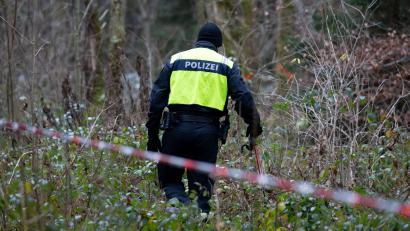 Bild: Sven Hoppe/dpa
Ein Polizist nimmt an der Durchsuchung von einem Waldstück im Forstenrieder Park teil.