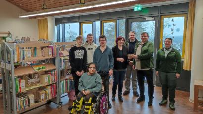 Bild: Konstantin Bayer
In der neu eingerichteten Bibliothek des Heilpädagogischen Zentrums wird die Spende von Herrn Arnold an die Förderschule übergeben.“ (von links: Schüler der Förderschule, Petra Rothmund, Sonderschulrektorin, Philipp Bahnmüller, Leiter Staatsforstbetrieb Schnaittenbach, Ludwig Arnold, Inventurleiter Nord Bayerische Staatsforsten und Christiane Arnold, Leiterin Staatsforstrevier Hessenreuth West)
