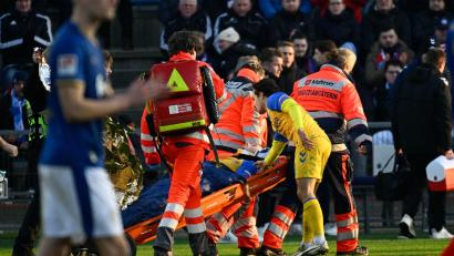 Bild: Gregor Fischer/dpa
Paderborns Spieler Calvin Brackelmann wird nach einer Verletzung von Sanitätern auf einer Trage vom Spielfeld gebracht.