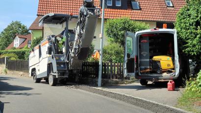 Bild: bsc
Mit einer Kleinfräse wird vor der unterirdischen Verlegung des Glasfaserkabels der Asphalt auf Straßen (im Bild am Blaslberg) und Bürgersteigen geöffnet.