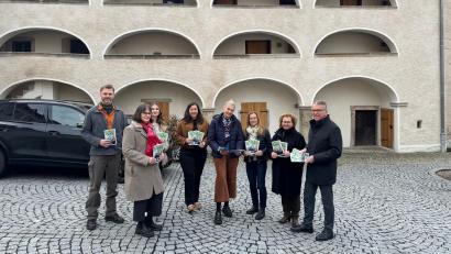 Bild: Stadt Tirschenreuth / Mirko Streich
Bürgermeister Franz Stahl mit den Gästeführerinnen Cornelia Stahl und Christina Zapf, Tourist-Info-Mitarbeiterin Susanne Stich, der Leiterin Tourist-Info/MQ Birgit Plößner, der stellvertrenden Leiterin der Tourist-Info Jessica Hecht, Tourist-Info-Mitarbeiterin Petra Römer sowie Stadtförster Stefan Gradl (von rechts) bei der Präsentation der Gästeführerbroschüre vor den Historischen Arkaden.