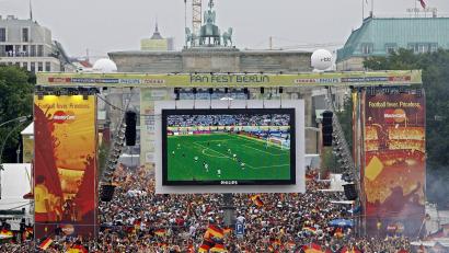 Bild: Marcel Mettelsiefen/dpa
Tausende Zuschauer verfolgen 2006 auf der Fanmeile am Brandenburger Tor in Berlin das WM-Fußballspiel zwischen Deutschland und Argentinien. (Archivfoto)