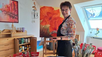 Bild: bl
Im Dachgeschoss über der Metzgerei am Unteren Markt in Nabburg ist Angelika Pesold in ihrem Element und kapert eine Hälfte des großen Esstisches für ihr Hobby, die Malerei.