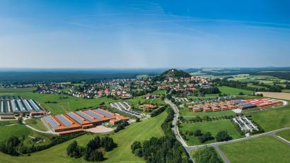 Bild: Witron
Ein Sinnbild für die Entwicklung der Oberpfalz: Unter dem Parkstein gab es bis in die 1970er Jahre nichts als Wiesen und Felder. Heute bietet der Technolgieführer im Bereich der Lagerlosgistik, Witron, hier Arbeitsplätze für tausende Menschen.