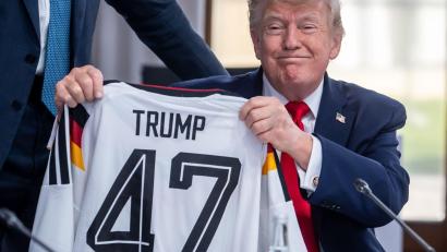 Bild: Michael Kappeler/dpa-Pool/dpa
Trump zeigt sein Geschenk zum 80. Geburtstag.