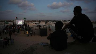 Bild: Abdel Kareem Hana/AP/dpa
Eine Leinwand mitten im Gazastreifen: Palästinenser verfolgen die Live-Übertragung des Fußball-WM-Spiels zwischen Spanien und Saudi-Arabien.