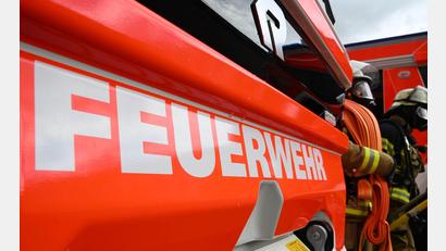 Bild: Bernd Weißbrod/dpa
Die Feuerwehr ging unter Atemschutz zur Brandbekämpfung an der Rundballenpresse vor. (Symbolbild)