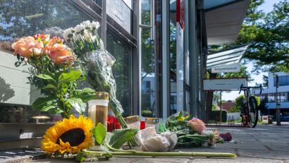 Bild: Armin Weigel/dpa
Menschen legten nach dem tödlichen Angriff Blumen und Kerzen vor der Filiale ab.