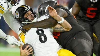 Bild: David Richard/AP/dpa
Steelers-Quarterback Aaron Rodgers wird von einem Cleveland-Verteidiger zu Fall gebracht.