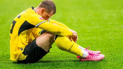 Bild: Julius Frick/dpa
BVB-Profi Julian Ryerson saß nach dem nächsten Rückschlag enttäuscht auf dem Rasen.