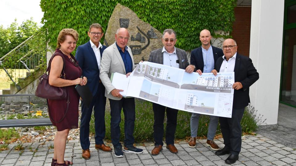 Projektkoordinatorin Thea Friedel (FUCHS Immobilien), Geschäftsführer Alois Scherer (3v.r.) und Vertriebskoordinator Marco Werner (2.v.r.) überreichten zusammen mit Architekt Theo Nutz (r.) und VR-Vorstand Andreas Reindl (2.v.l.) den Stadtgarten-Plan an Bürgermeister Roland Strehl (3.v.l.) Bild: Fuchs &amp; Söhne