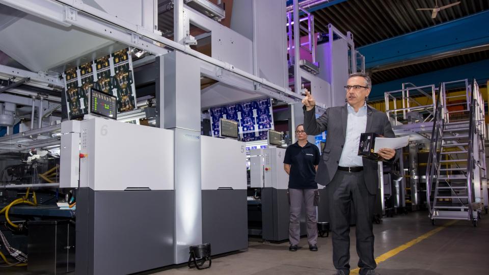 Während Mitarbeiter die Anlage betreiben, erläuterte Produktmanager Werner Schwab bei den „Boardmaster Demo-Days“ den Ablauf der Maschine, die 600 Meter Papierverpackung in der Minute produziert. Bild: fz