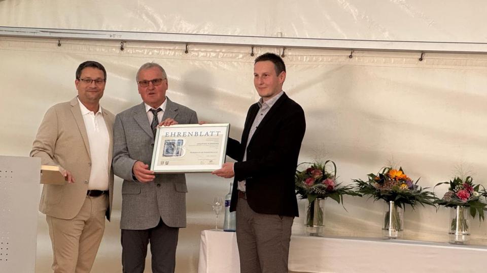Handwerkskammer-Geschäftsführer Alexander Stahl überreichte das Ehrenblatt zum 30-jährigen Bestehen des Unternehmens an die Familie Schneider. Bild: exb/Holz-Bösl